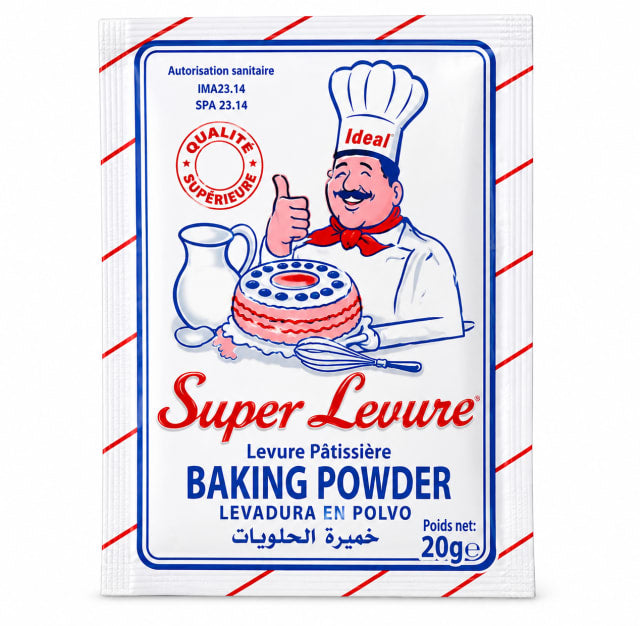 A single packet of Super Levreuse Baking Powder, featuring a white background with red and blue borders, a cartoon chef giving a thumbs-up, and product text in French and Arabic.
