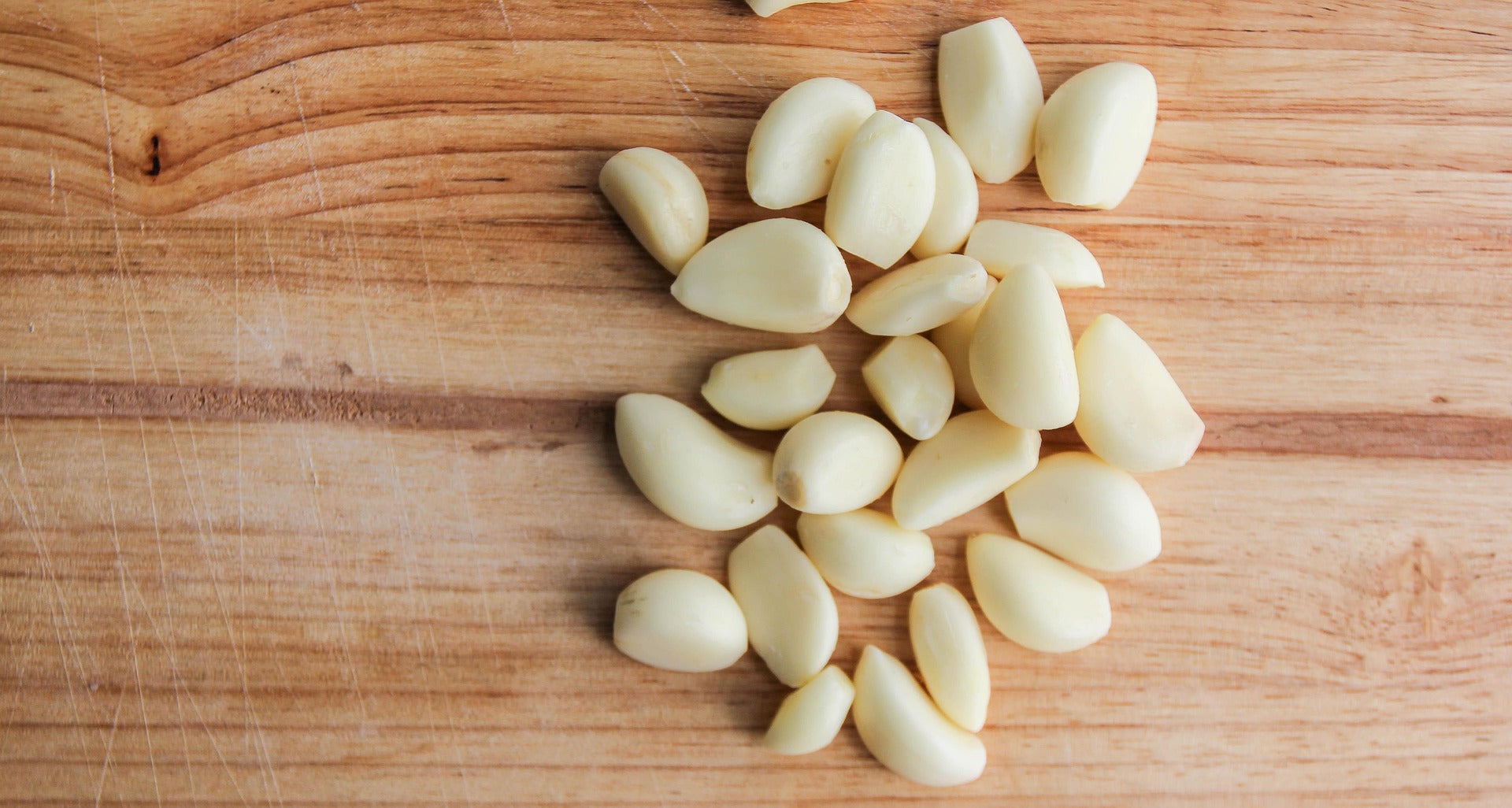 Garlic cloves on a wooden cutting board